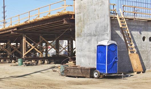 rows of portable restrooms at a job site, providing essential amenities for workers